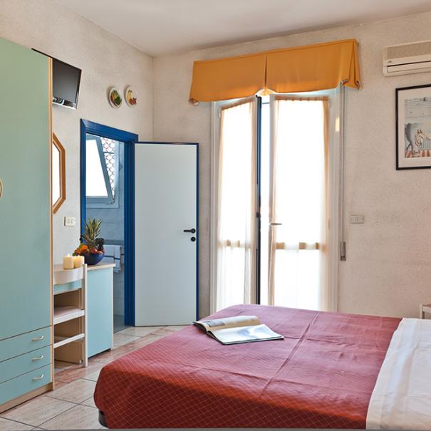 Bright bedroom with modern furnishings and window.